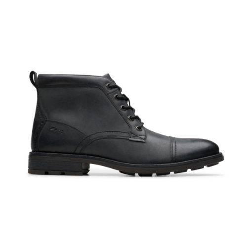 Profile of black leather ckukka boot with detailed stitching, black laces and black treaded outsole.