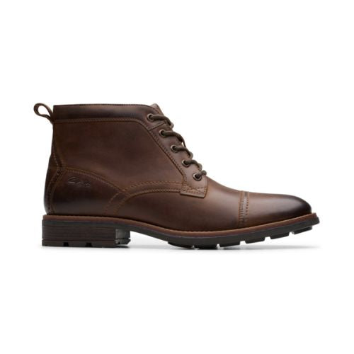 Profile of dark brown leather ckukka boot with detailed stitching, brown laces and black treaded outsole.