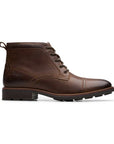 Profile of dark brown leather ckukka boot with detailed stitching, brown laces and black treaded outsole.