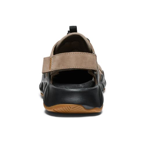 Heel strap of brown leather fisherman sandal with black rubber outsole.