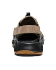 Heel strap of brown leather fisherman sandal with black rubber outsole.