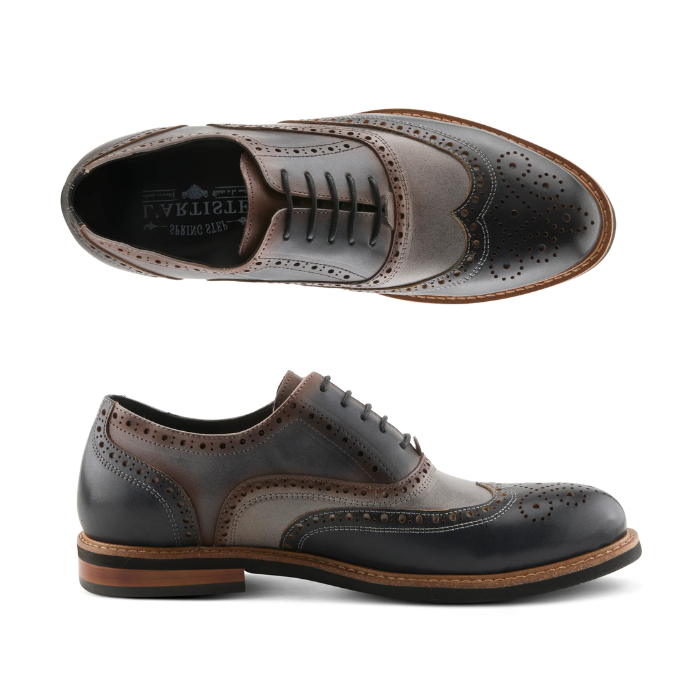 Pair of Gray, navy and black oxford wingtip brogue shoes with laces, burnished finish, tan midsole and black outsole.