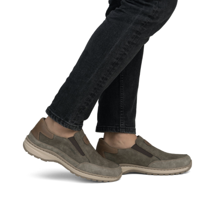 Brown slip-on shoes worn with black jeans.