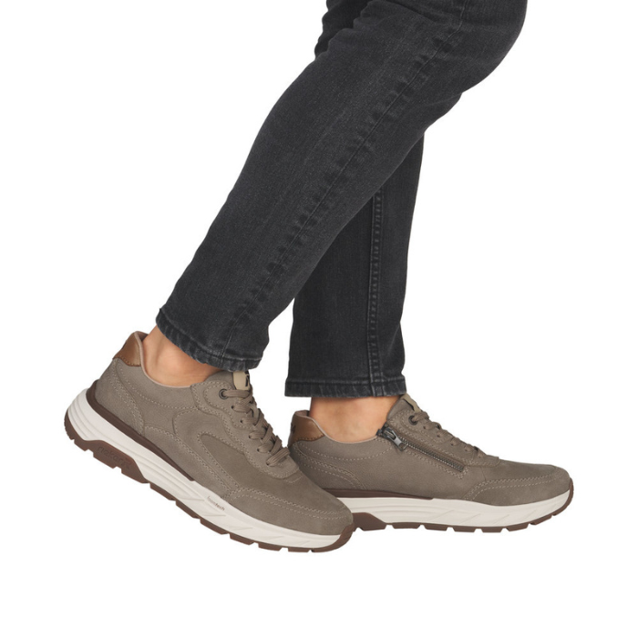 Brown sneakers worn with black jeans.