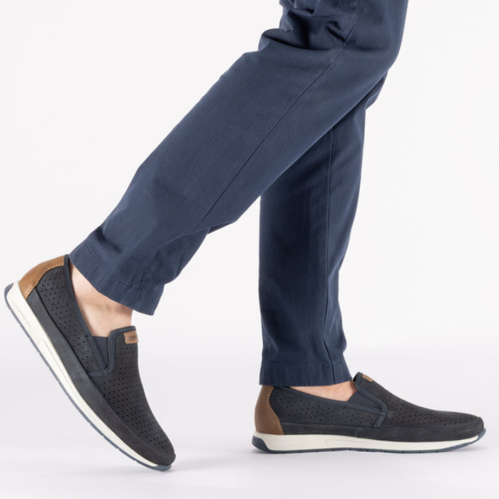 Dark blue slip-on shoes worn with navy pants.