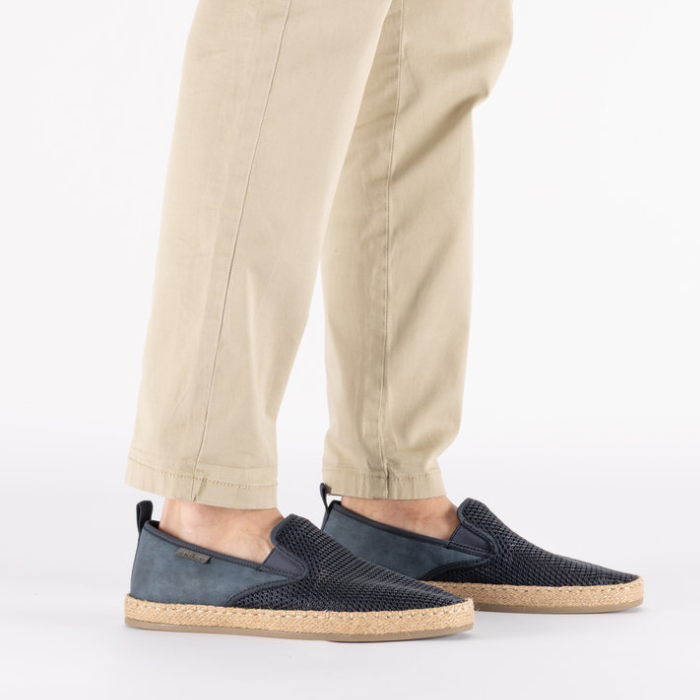 Navy mesh loafers worn with beige pants.