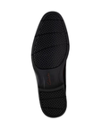 Black light treaded outsole of a dress shoe.