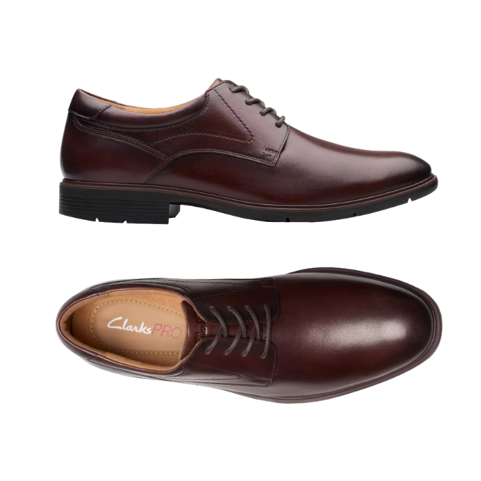 Pair of Dark Brown leather derby dress shoes with stitching details, tan ClarksPro logo'd footbed and low heel. 