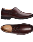 Pair of Dark Brown leather derby dress shoes with stitching details, tan ClarksPro logo'd footbed and low heel. 