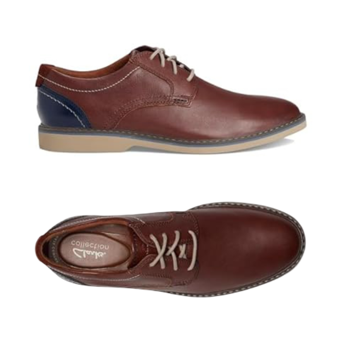 Pair of Brown leather derby dress shoes with navy heel accent, beige laces, tan Clarks logo'd footbed and beige outsole.