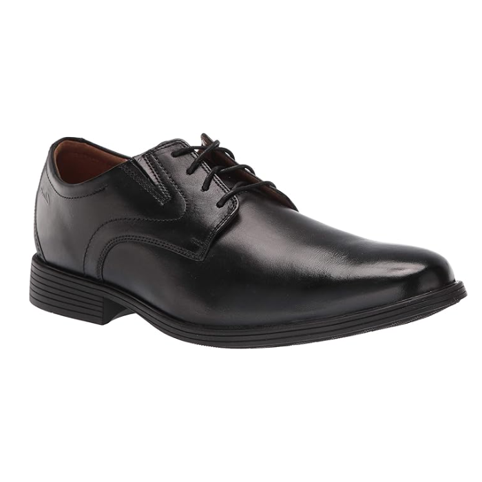 Black leather derby dress shoe with stitching details and low heel. 