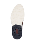 Rubber outsole, half white and half navy with red Rieker logo on navy part at heel.