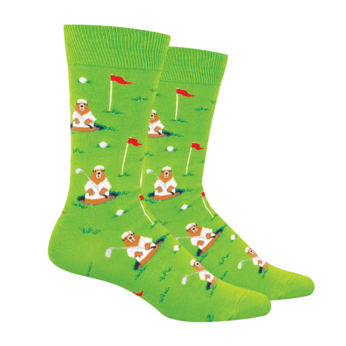 Green socks with gophers wearing white golf clothes, holding a putter while sitting in a hole beside the red flag of a golf course.