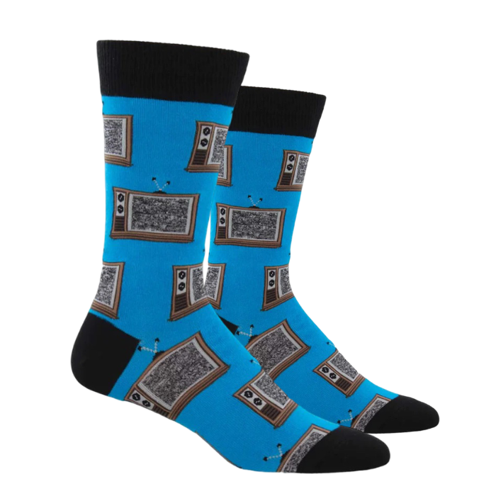 A pair of bright blue crew socks with black cuffs, heels, and toes, featuring a print of staticky vintage tvs.