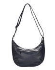 Back of a dark navy crescent-shaped shoulder bag with a long adjustable strap and a zippered front pocket.
