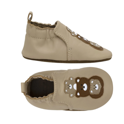 Pair of Beige baby shoes with 3 bears pattern and cinched cuff.