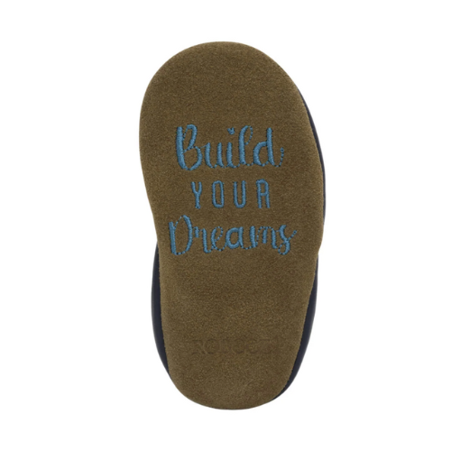 Brown suede outsole with 'Build Your Dreams' text.