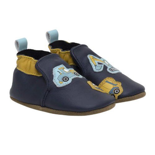 Pair of navy blue baby shoes with yellow accents and construction vehicle's on toe, cinched cuff and blue pull tab.