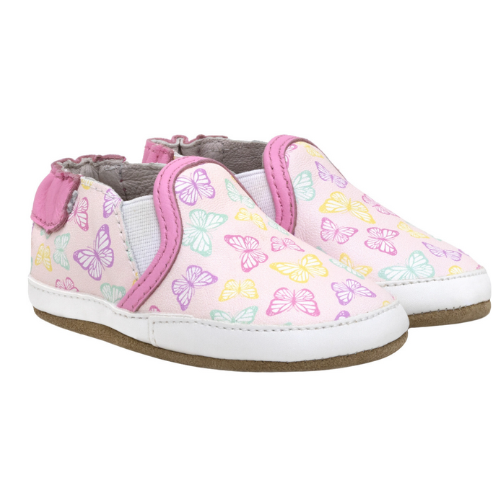 Pair of baby's shoes with purple, pink, green and yellow butterfly pattern.
