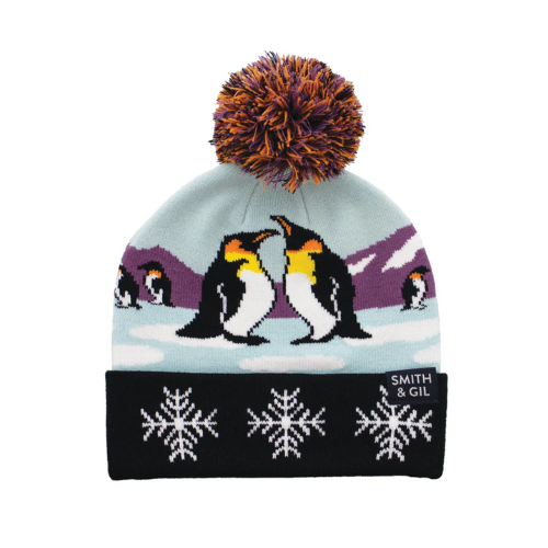 Blue knitted beanie with penguins design, orange an purple pom-pom and black cuff with large snowflake pattern.