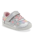 A toddler's pastel rainbow mesh and silver leather sneaker with a hook-and-loop strap, pastel pink laces, and iridescent floral appliques on the side and white outsole.