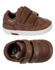 Pair of Brown children's shoes with two Velcro straps and white soft motion outsole.