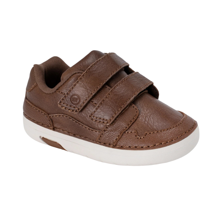 Brown children's shoe with two Velcro straps and white soft motion outsole.