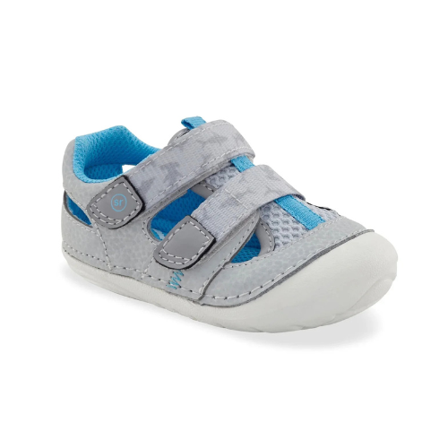 A light grey toddler sandal with two hook-and-loop straps, blue accents, blue lining and white outsole.