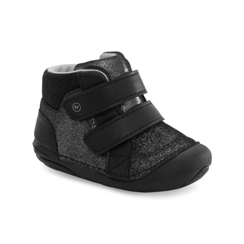 A black high-top baby bootie featuring a textured glittery black upper, a black knit ankle collar, and two wide black hook-and-loop straps.