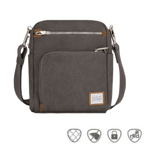 Pewter grey canvas crossbody locking strap bag with two locking front zipper pockets, Travelon logo in corner, anti-theft feature icons across bottom.