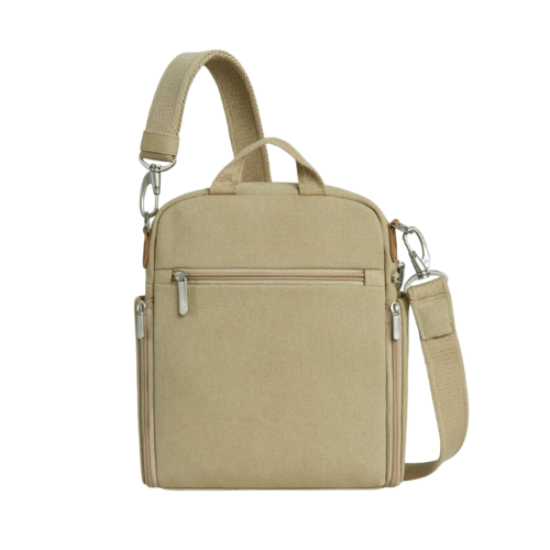 Beige crossbody bag with silver zippers back zippered pocket and small top handle. 