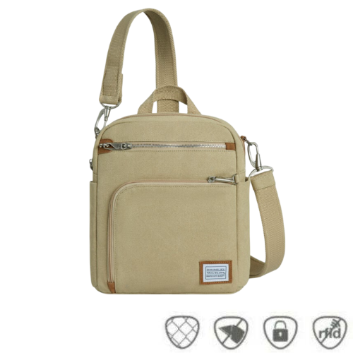 Natural beige canvas crossbody locking strap bag with two locking front zipper pockets, Travelon logo in corner, anti-theft feature icons across bottom.