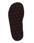 Outsole of a brown slipper with repeating pattern of small red circular dots (traction dots).