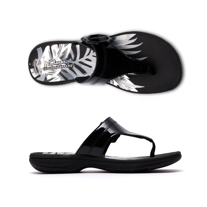 Pair of Black patent thong sandals with a black octagonal buckle, floral white Clarks logo'd footbed and black outsole.