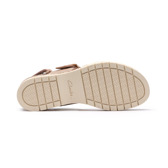 Beige light treaded outsole of wedge sandal with Clarks stamped in middle.