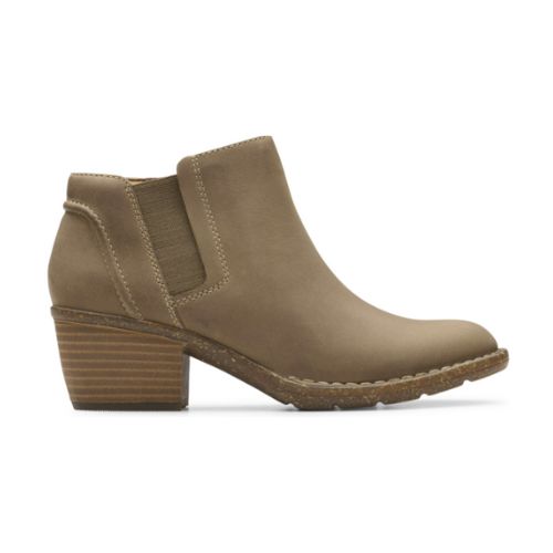 Low Block heel beige ankle boot with side goring, detailed stitching and brown rocker shaped outsole.