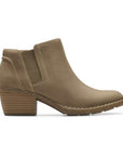 Low Block heel beige ankle boot with side goring, detailed stitching and brown rocker shaped outsole.