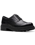 A black leather derby lace shoe with a chunky rubber outsole and intricate baroque details.