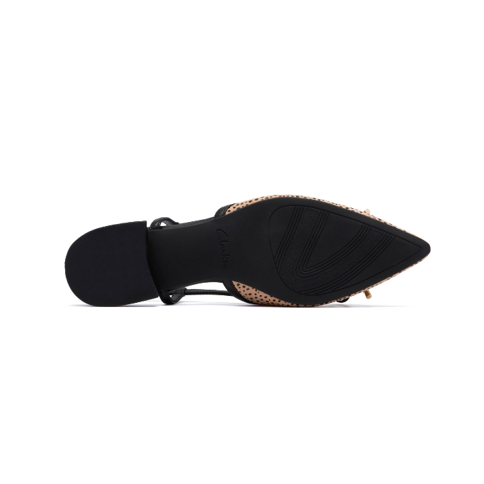 Black light treaded outsole of pointed toe shoe with low block heel.