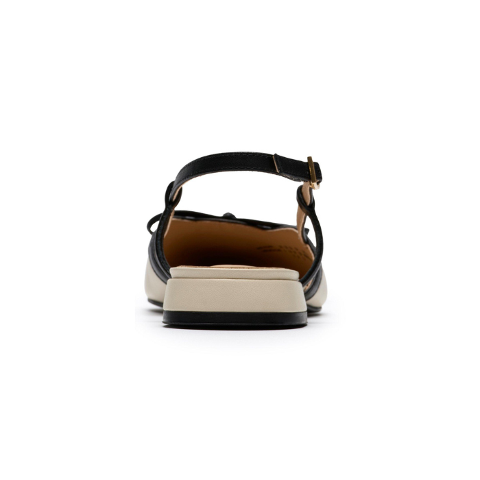Heel of Pointed-toe slingback flat with black bow detail, cream upper and a low block heel.