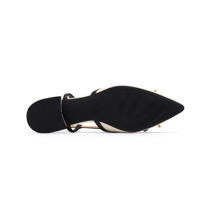 Black light treaded outsole of pointed toe shoe with low block heel.