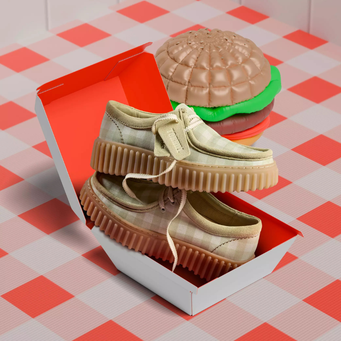 Sage platform sneakers displayed in hamburger box on picnic table cloth and hamburger decor beside it.