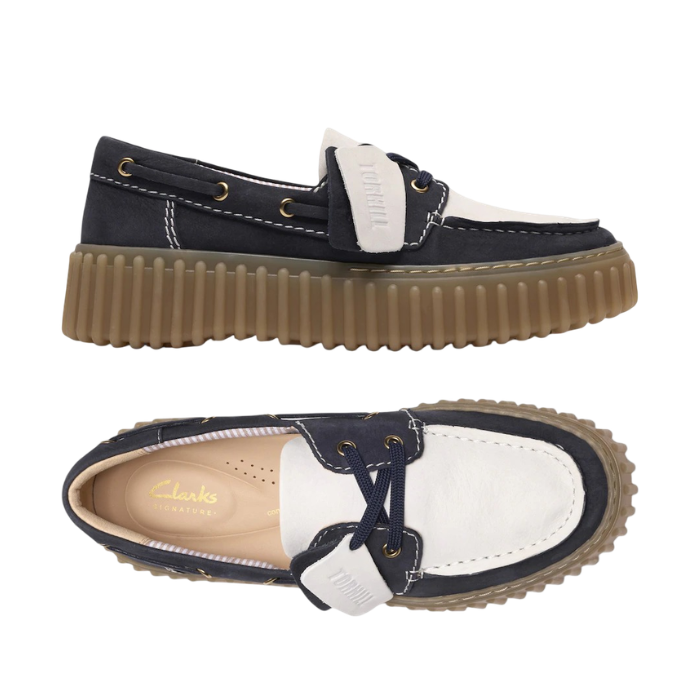 Pair of Navy and white boat shoes with a tan Clarks logo'd footbed and  thick brown ribbed outsole.
