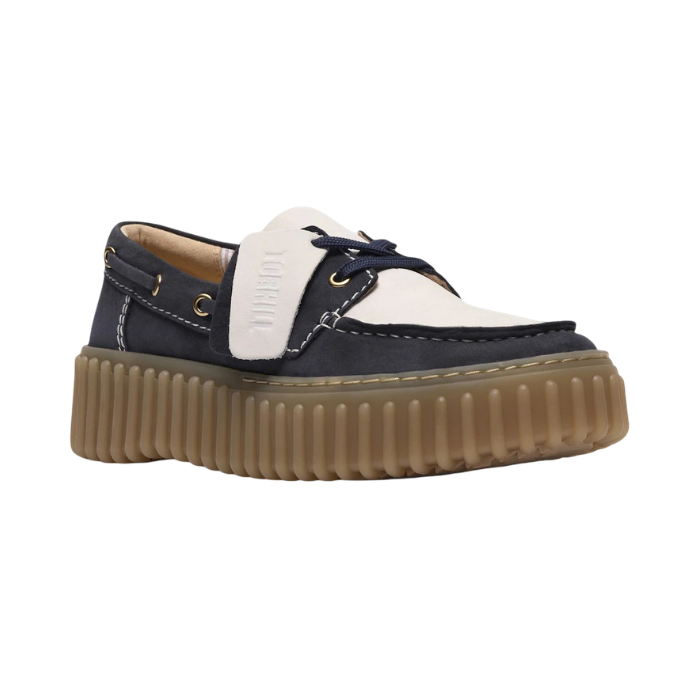 Navy and white boat shoe with a thick brown ribbed outsole.
