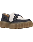 Navy and white boat shoe with a thick brown ribbed outsole.