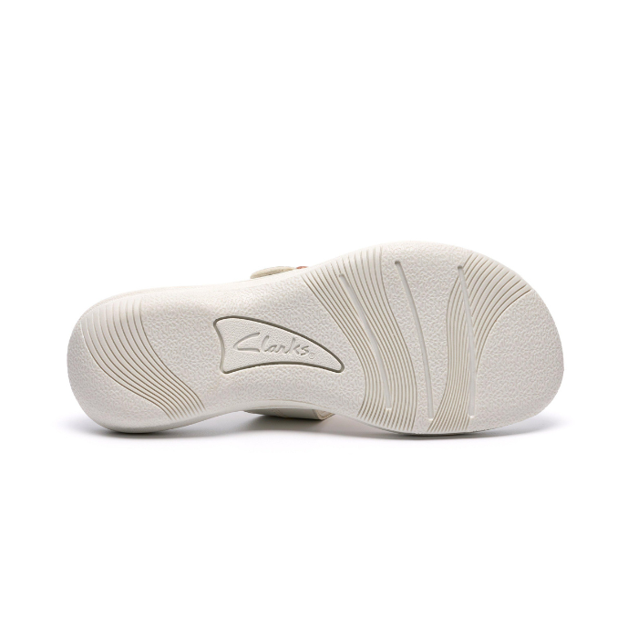 White outsole of sandal with light wave pattern tread and Clarks logo in middle.