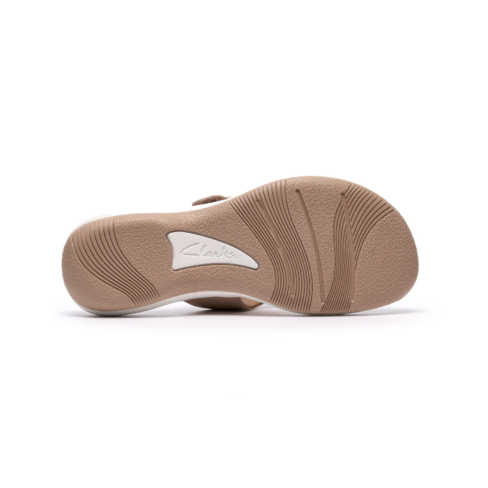 Beige outsole with light wave pattern tread and white Clarks logo in middle.