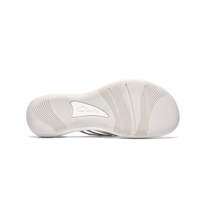 Light wave pattern treaded outsole of thong sandal with Clarks logo in middle.