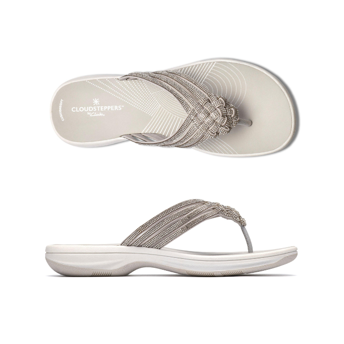 Pair of Silver thong sandals with multiple decorative straps covered in rhinestones, white Clarks logo'd footbed and thick cushioned outsole.