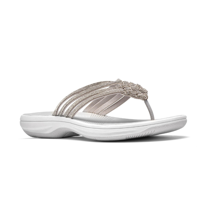 Silver thong sandal with multiple decorative straps covered in rhinestones, white Clarks logo'd footbed and thick cushioned outsole.